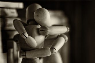 Wooden figures hugging