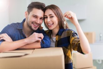 couple holding key to new home