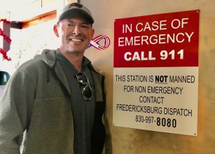 Aaron in front of an emergency sign