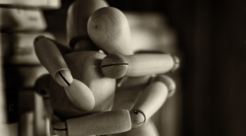 Wooden figures hugging